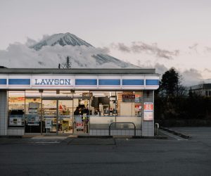Lawson store with Mount Fuji in the background during day, showcasing urban convenience and natural beauty.